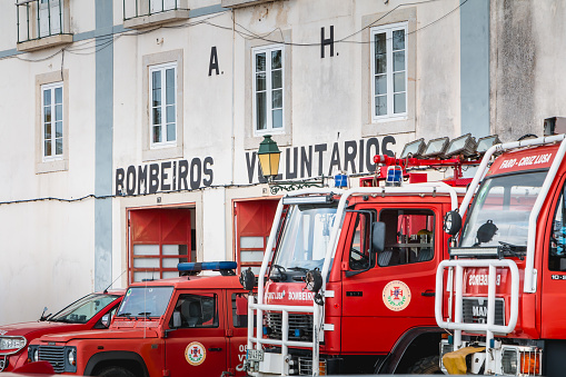 Faro, Portugal - May 01, 2018: Fire trucks parked in front of a volunteer fire station on a spring day