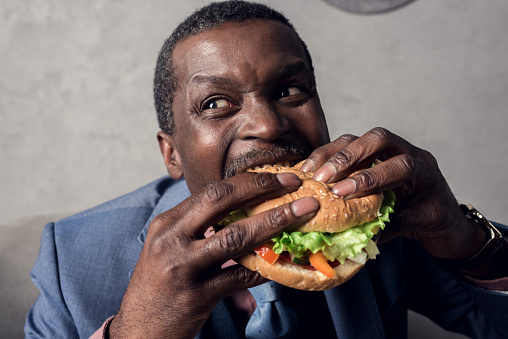 Hungry African American Businessman Eating Hamburger Stock Photo - Download  Image Now - iStock