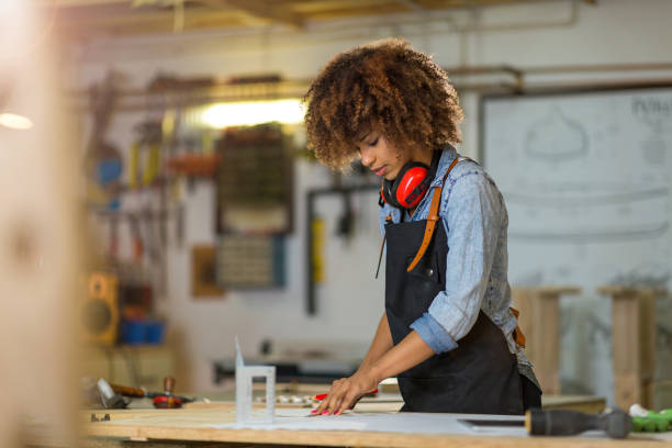 istock Young woman doing woodwork in a workshop 973213446