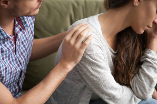 istock Helping caring husband apologizing comforting wife, support in marriage concept 973216350