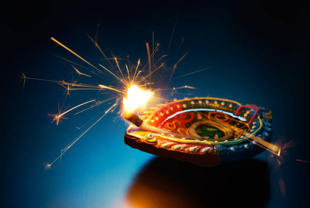istock Sparkling effect on a lit diya lamp 973216516