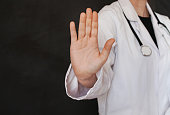 Female doctor making stop sign with her hand