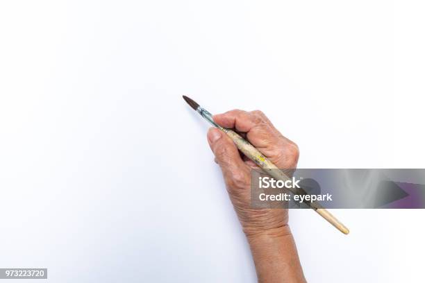 Senior Womans Hand Painting With Paintbrush Isolated On White Background Stock Photo - Download Image Now