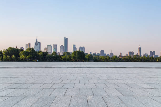 istock Panoramic skyline and modern business office buildings with empty road,empty concrete square floor 973258428