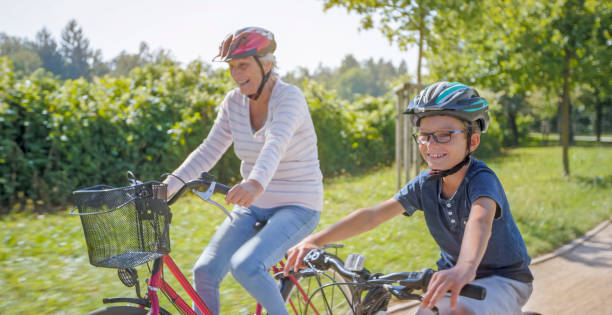 istock Grandmother and grandson riding bicycle 973258782