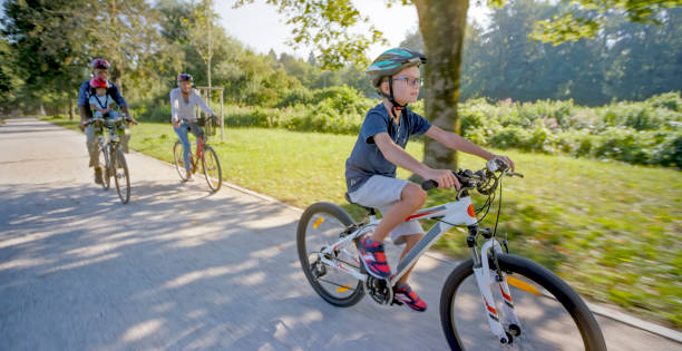 istock Family riding bicycle in park 973258796
