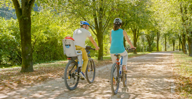 istock Family riding bicycle in park 973258830