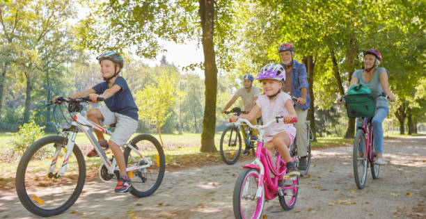 istock Family riding bicycle in park 973258832