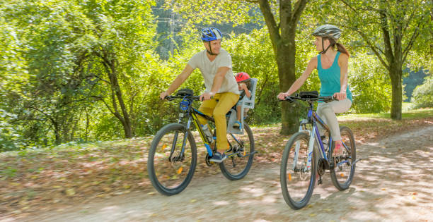 istock Family riding bicycle in park 973258834