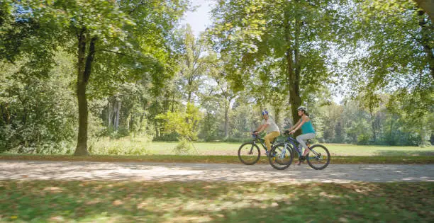 Photo of Family riding bicycle in park