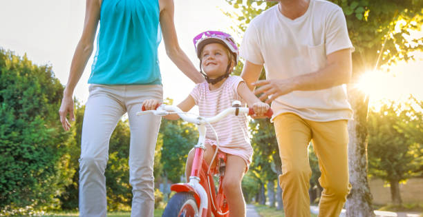 istock Mother and father helping their daughter 973258876