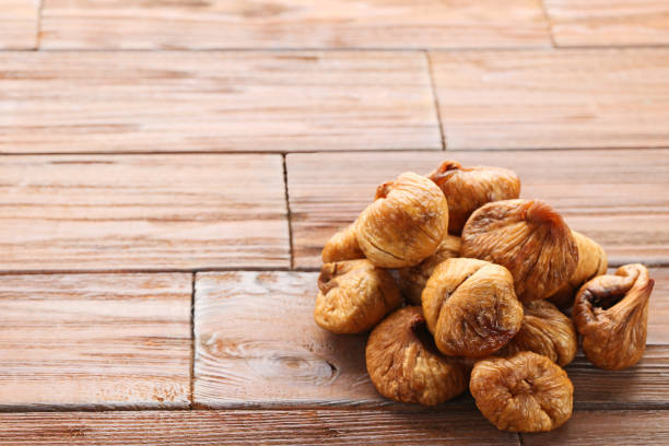 Dried figs on brown wooden table