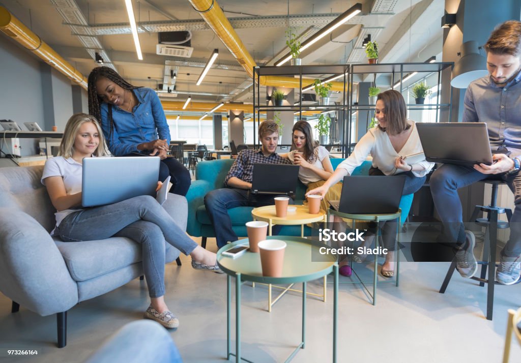 Young coworkers in modern office Young people making strategy for startup business in casual co working space Coworking Stock Photo