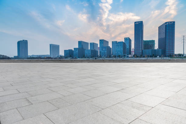 istock Panoramic skyline and modern business office buildings with empty road,empty concrete square floor 973267020
