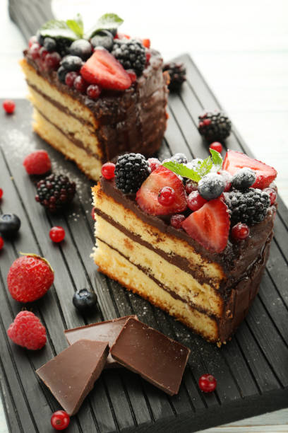 istock Pieces of chocolate cake with berries on cutting board 973267162
