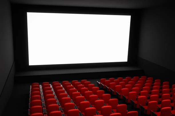 istock Cinema auditorium with white blank screen and red seats 973267390