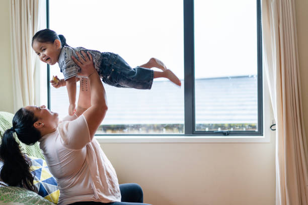istock Mother playing with her son at home. 973267554
