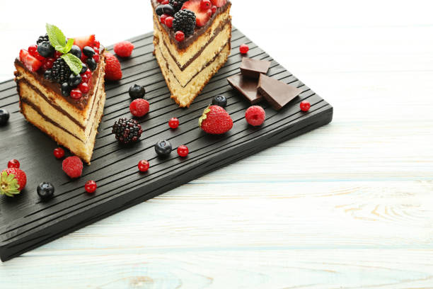 istock Pieces of chocolate cake with berries on cutting board 973269970