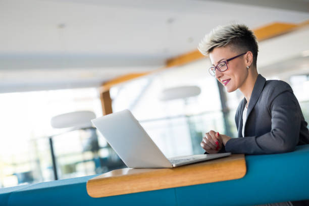 istock Attractive young female architect working on laptop 973270436