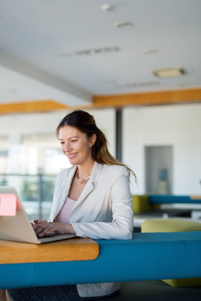 istock Attractive young female architect working on laptop 973270608