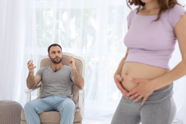 istock Handsome man admiring pregnant woman 973270758