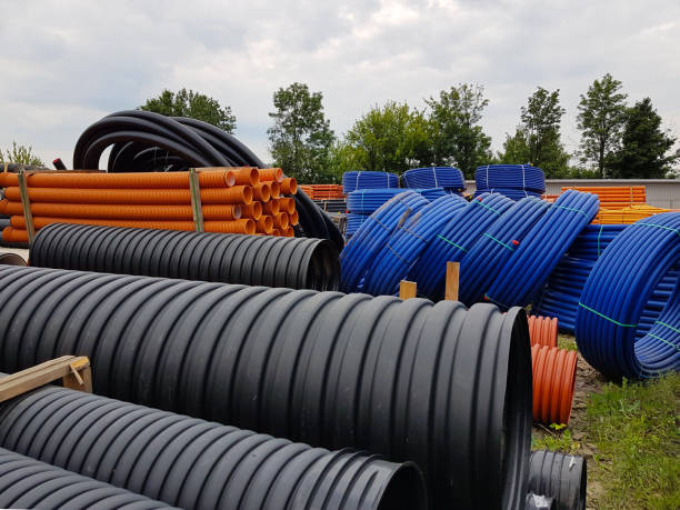 istock A warehouse of plastic pipes for various purposes, diameter and color under the open sky. Manufacture and sale of plastic products for construction works. Drainage and sewerage. 973271148