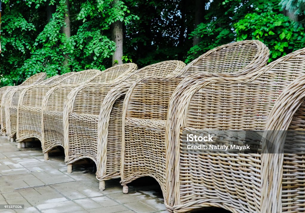 wicker chairs in a row in the park wicker chairs in a row in the park. 1980-1989 Stock Photo