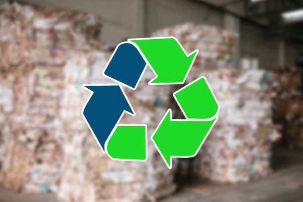 istock Sign recycling waste. The waste sorting and processing plant is blurry in the background 973271530