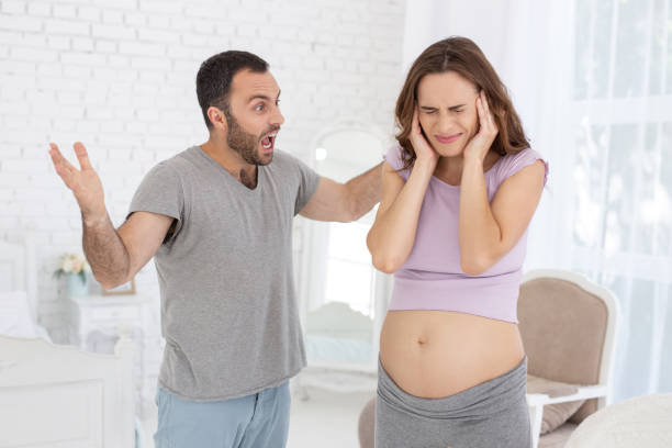 istock Angry man and pregnant woman disputing 973271644