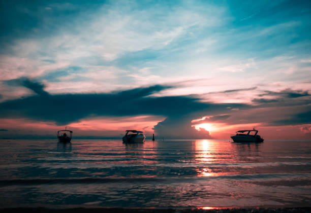 Picturesque seascape of sunset with speed boats