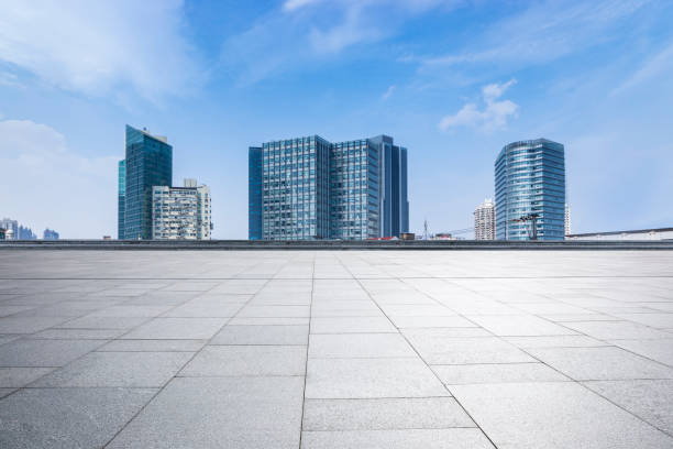 istock Panoramic skyline and modern business office buildings with empty road,empty concrete square floor 973275270