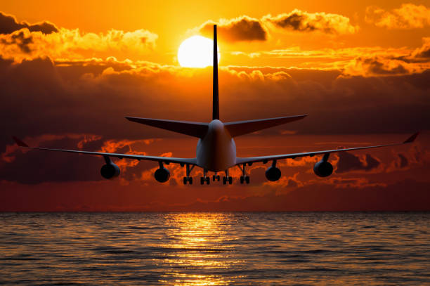istock Silhouette of an airplane on sunset 973277626