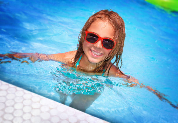 istock Cute little girl in the pool 973278906
