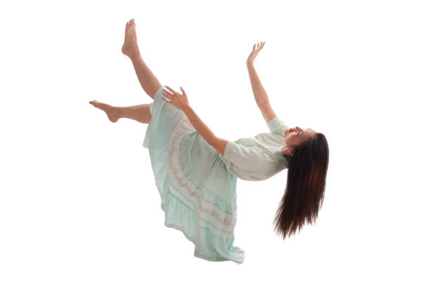 istock Woman in dress fall over behind on a white bottom 973284130