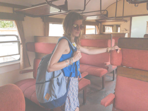 istock Girl with rucksack inside the old retro wagon. 973284638