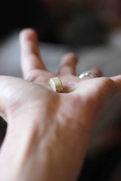 istock Woman hand showing a vitamine pill 973285126