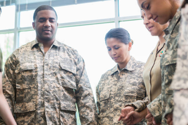 istock Group of soldiers pray together 973288874