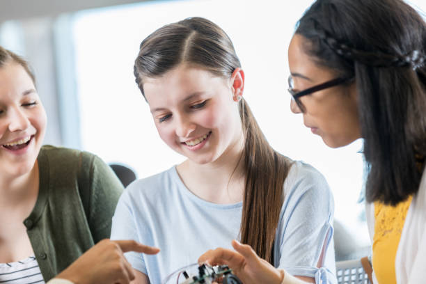 istock Teenage girls build robot in tech class 973289280