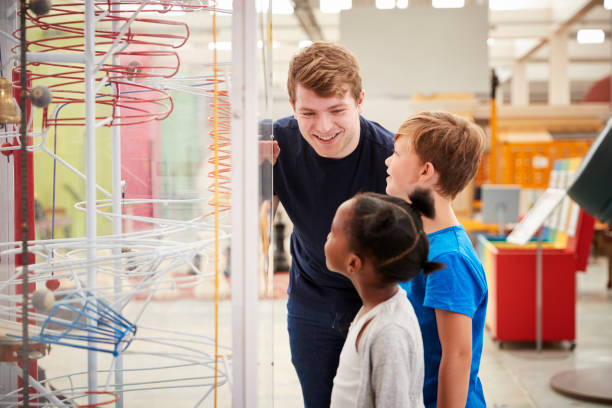istock Teacher and kids talking about a science exhibit 973292518
