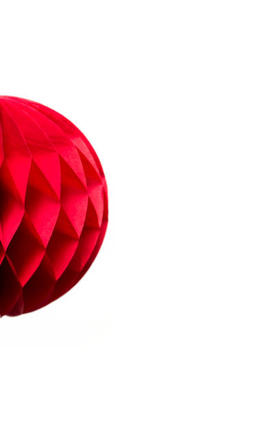 Red honeycomb  paper ball decoration isolated on white background