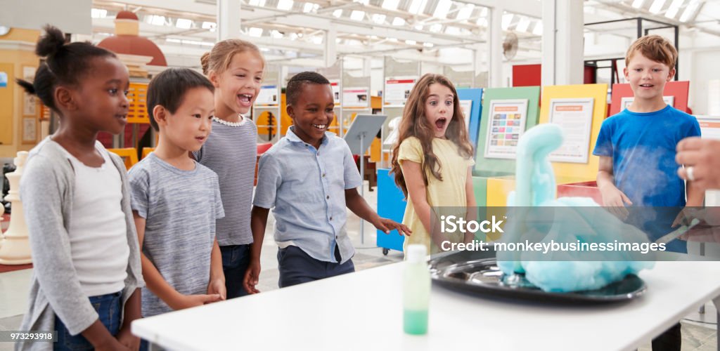 Kids having fun watching an experiment at a science centre Child Stock Photo