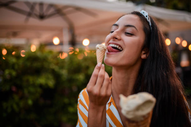 istock Smiling woman eating icecream. 973294398