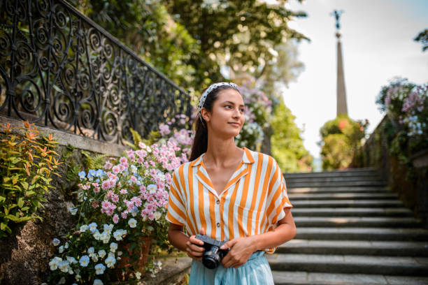 Smiling female tourist with camera.