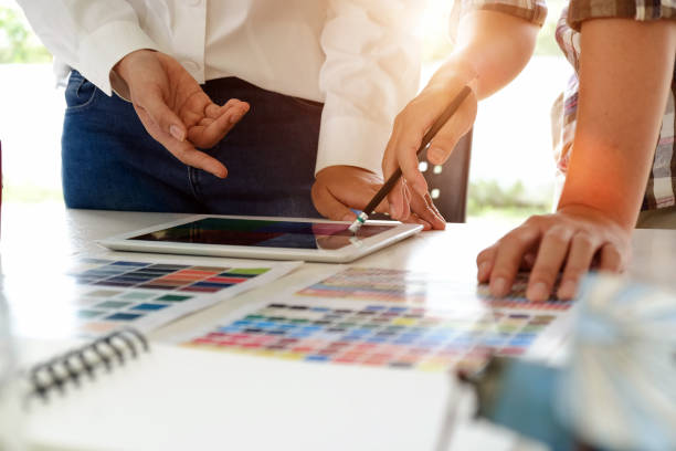 istock Team of creative designers working with tablet for new project in a design studio 973296760