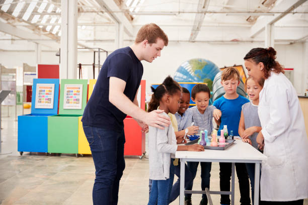 istock School kids taking part in an experiment at a science centre 973296850