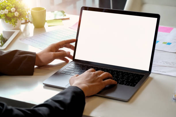 istock Businessman hands using laptop at office desk 973296914
