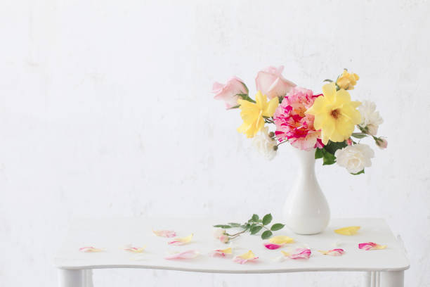 istock roses oin vase on white background 973297130