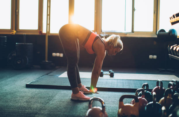 istock Blonde warming up in gym 973297522
