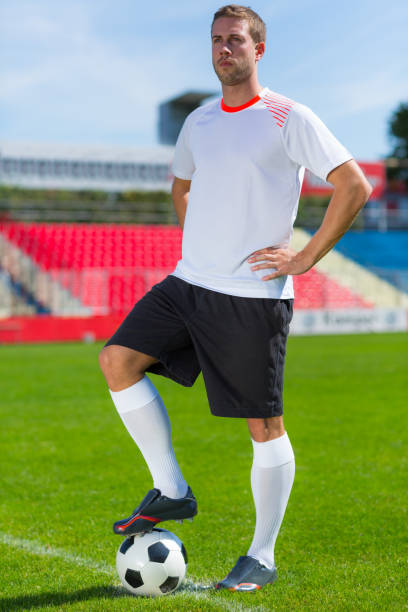 istock football player with soccer ball 973297718