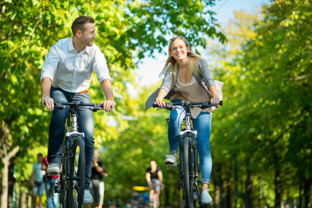 istock smiling couple cycling in park 973300810